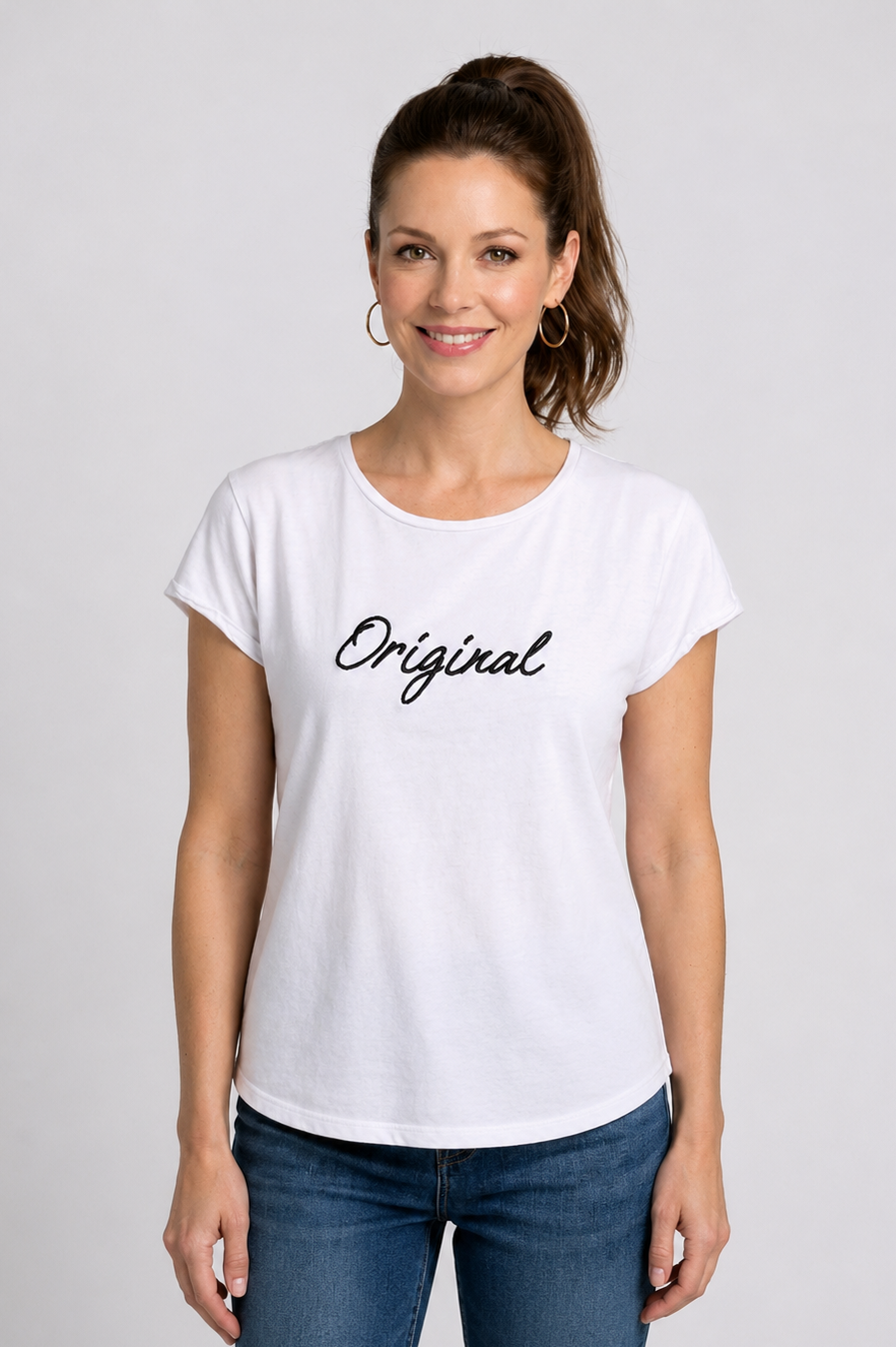 Woman wearing a white t-shirt with 'Original' text on 