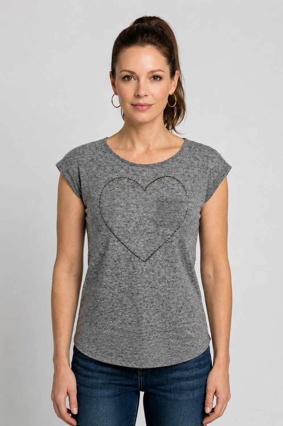 Woman wearing a grey t-shirt with a heart design 