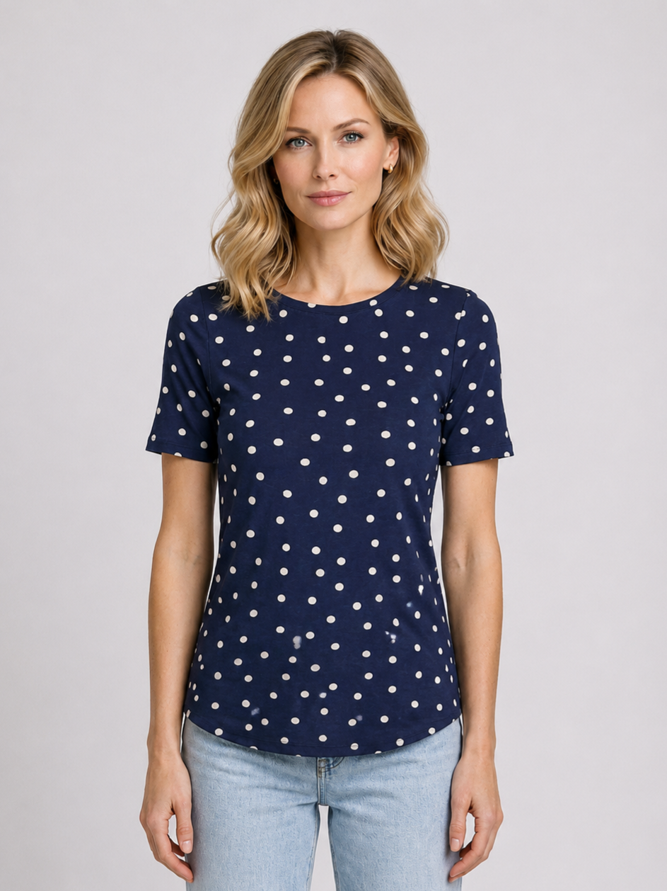 Woman wearing a navy blue t-shirt with white polka dots 