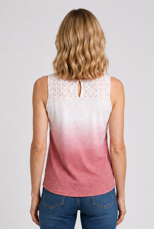 Woman wearing a sleeveless ombre top and blue jeans