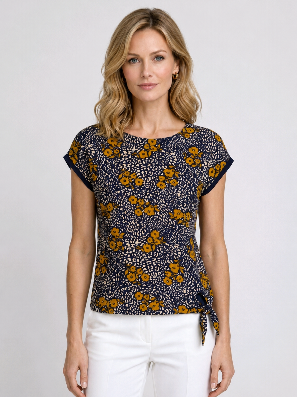 Woman wearing a floral patterned top with white 