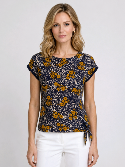 Woman wearing a floral patterned top with white 