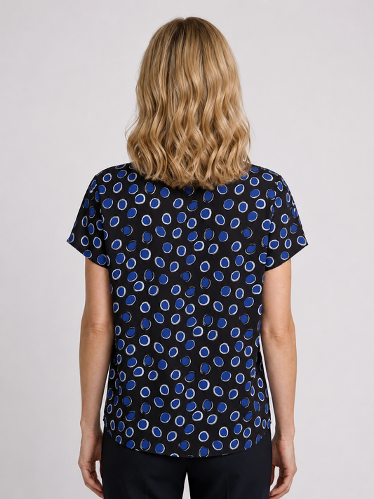 Woman wearing a black top with blue pattern 