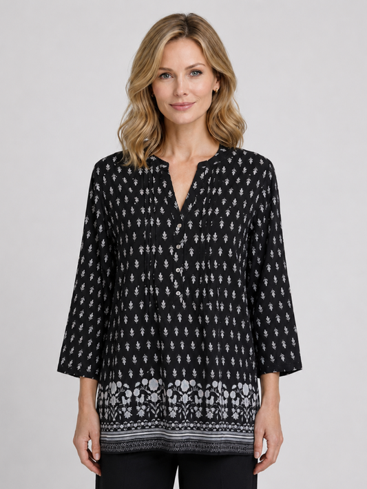 Woman wearing a black patterned blouse