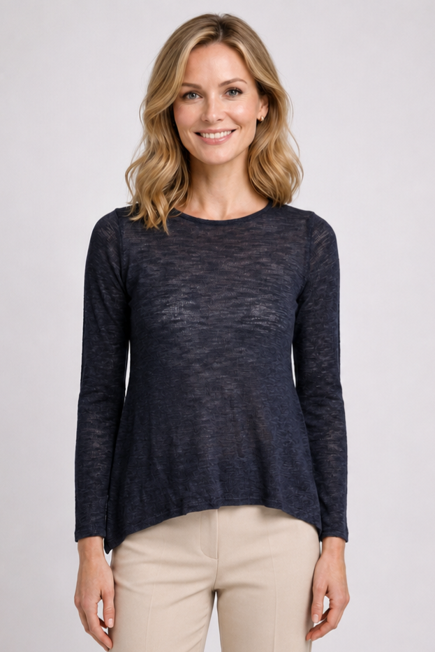 Woman wearing a navy long-sleeve top and beige trousers