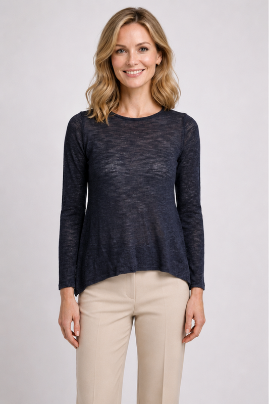 Woman wearing a navy long-sleeve top and beige trousers