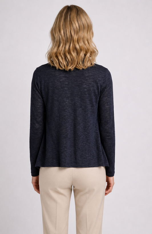 Woman wearing a navy long-sleeve top and beige trousers