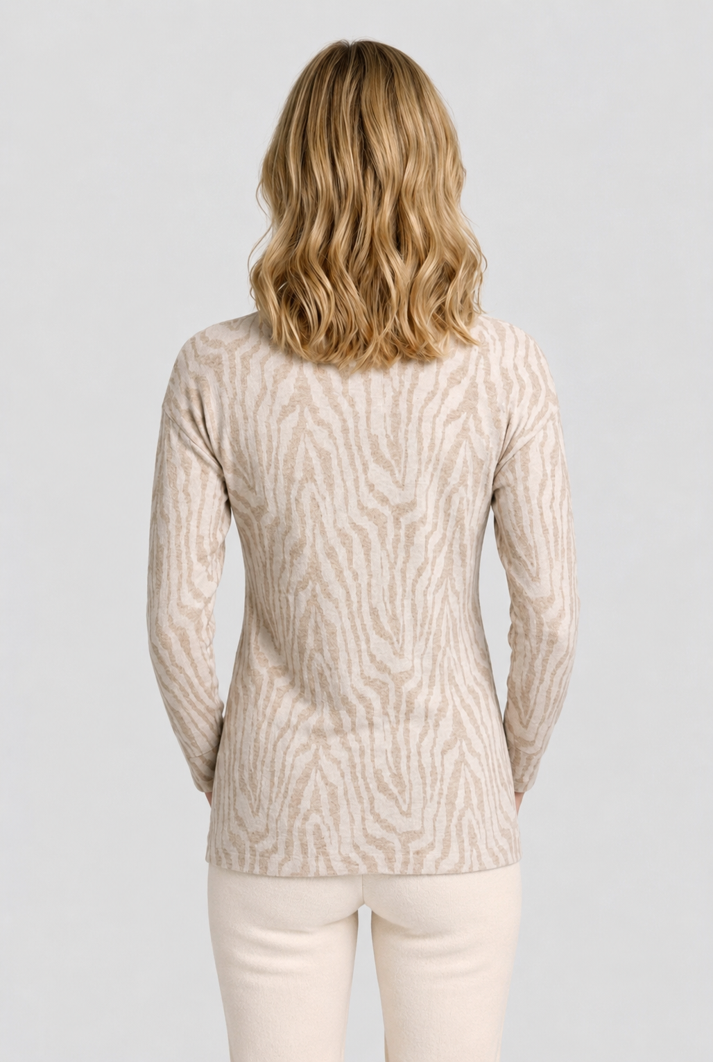 Woman wearing a beige pattern sweater 
