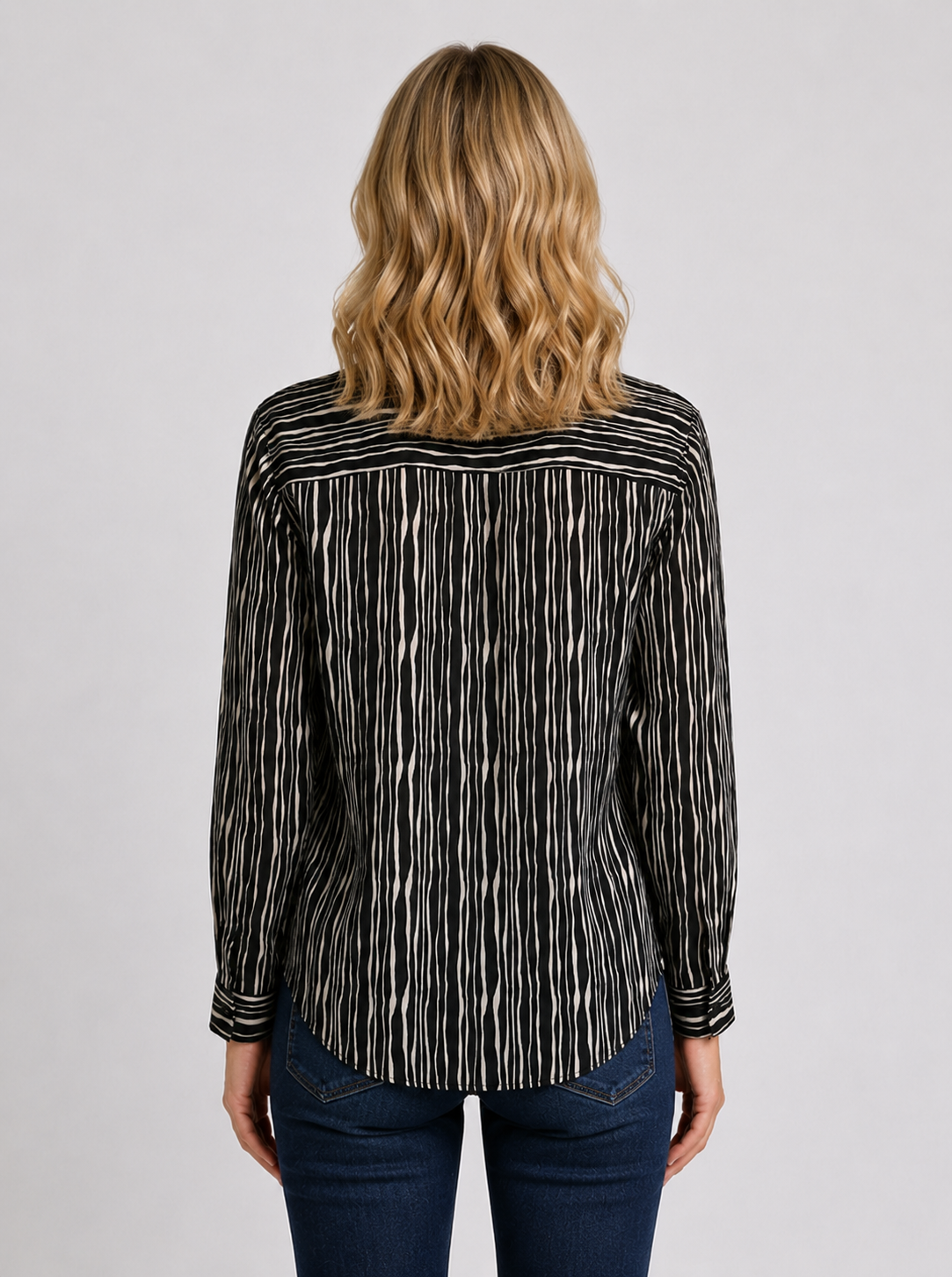 Woman wearing a black and white patterned shirt 