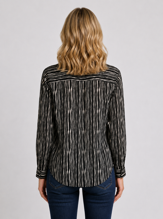 Woman wearing a black and white patterned shirt 