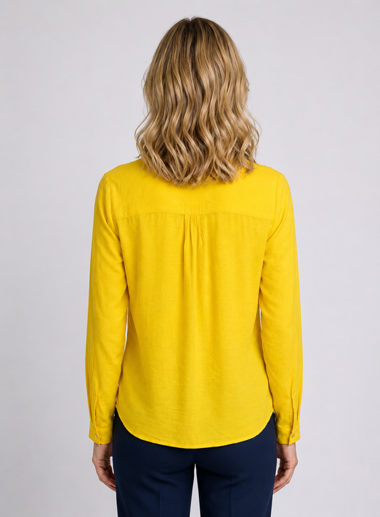 Woman wearing a yellow long-sleeve blouse