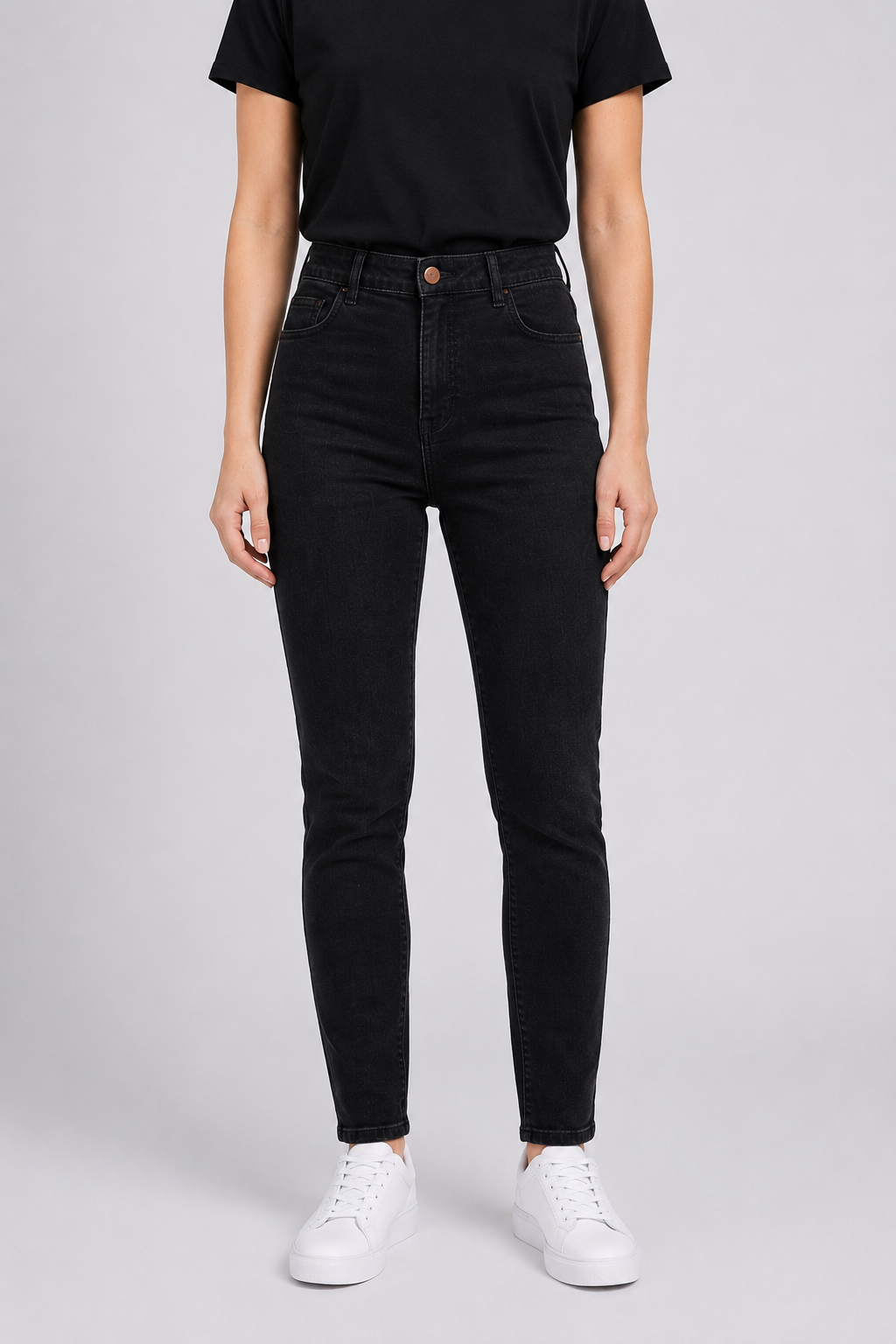 woman wearing black jeans and a black shirt on a white background