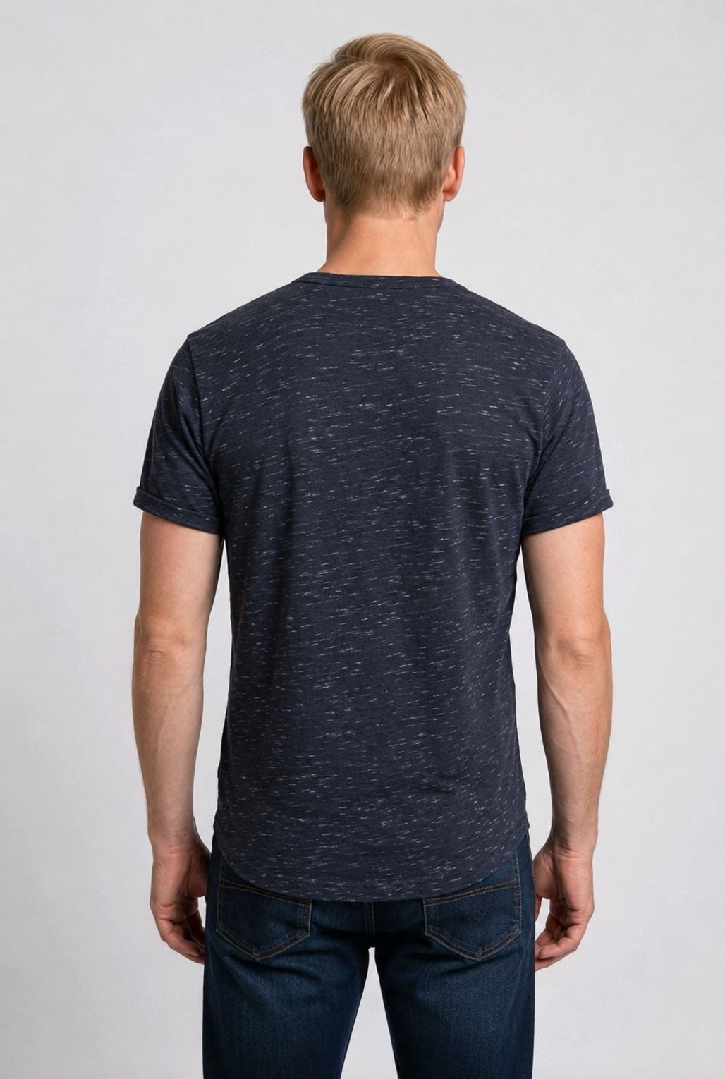 Man wearing a dark blue t-shirt and jeans 