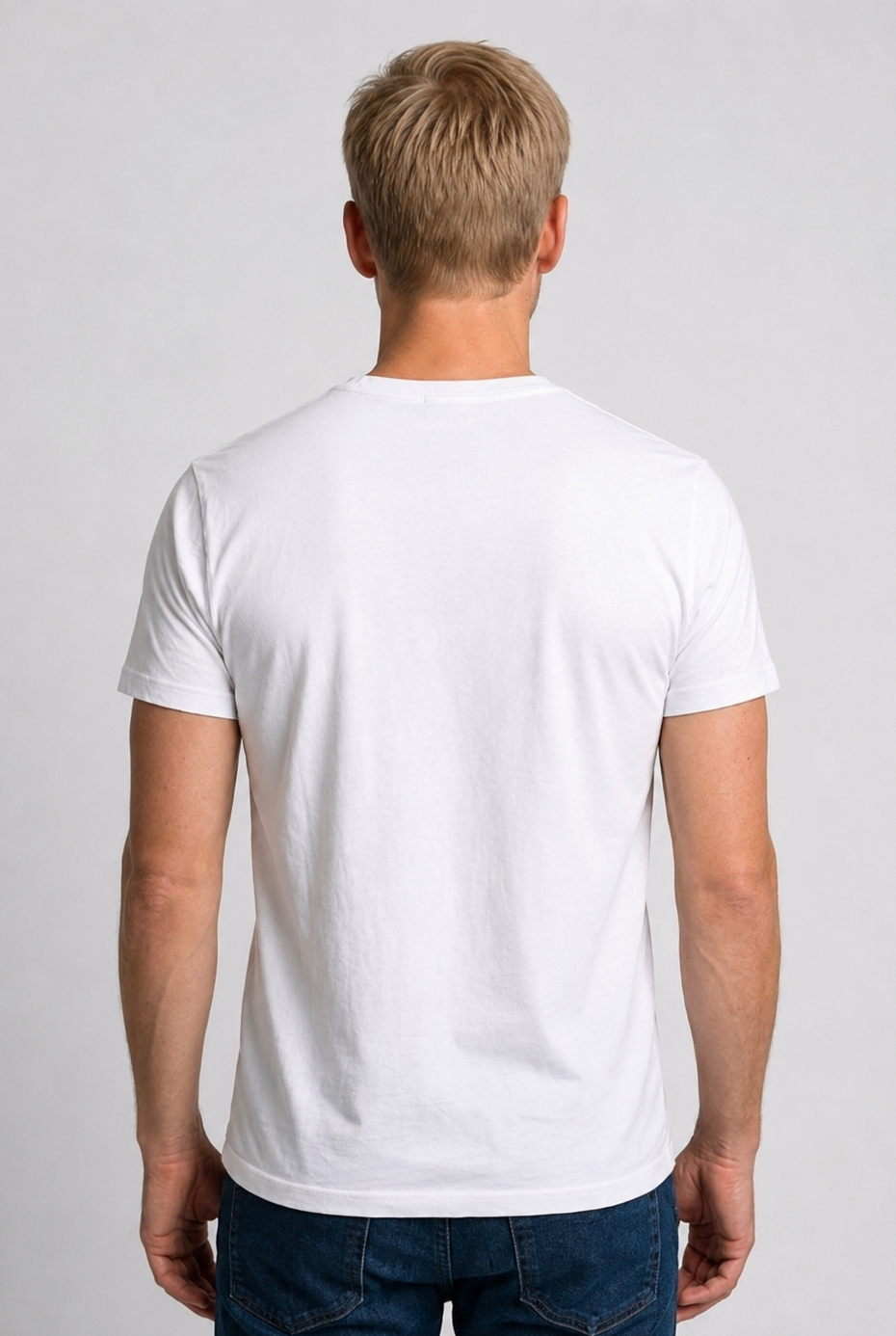 Man wearing a plain white t-shirt and dark jeans