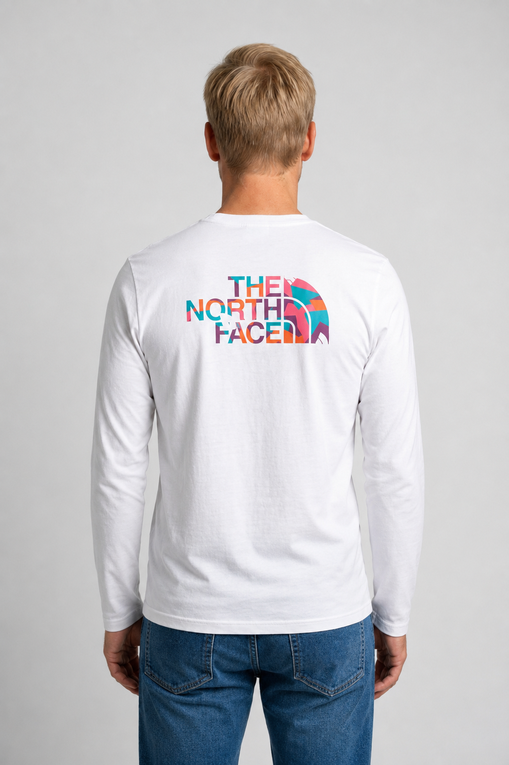 Person wearing a white long-sleeve shirt with The North Face logo on the back