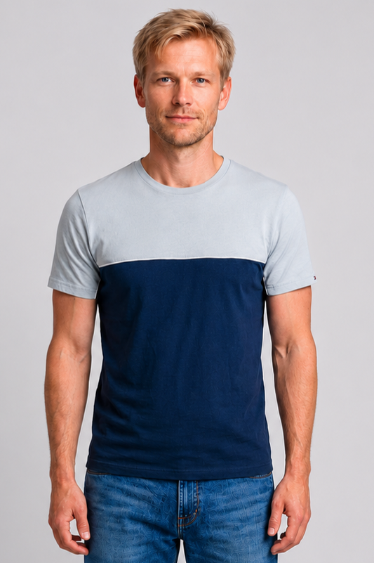 Man wearing a two-tone t-shirt with a light blue upper half and navy blue lower half 