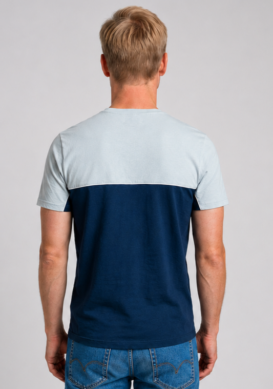 Man wearing a two-tone t-shirt with light blue sleeves and navy body