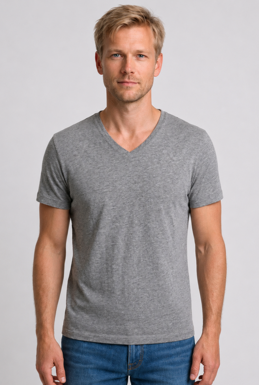 Man wearing a gray V-neck t-shirt and blue jeans 