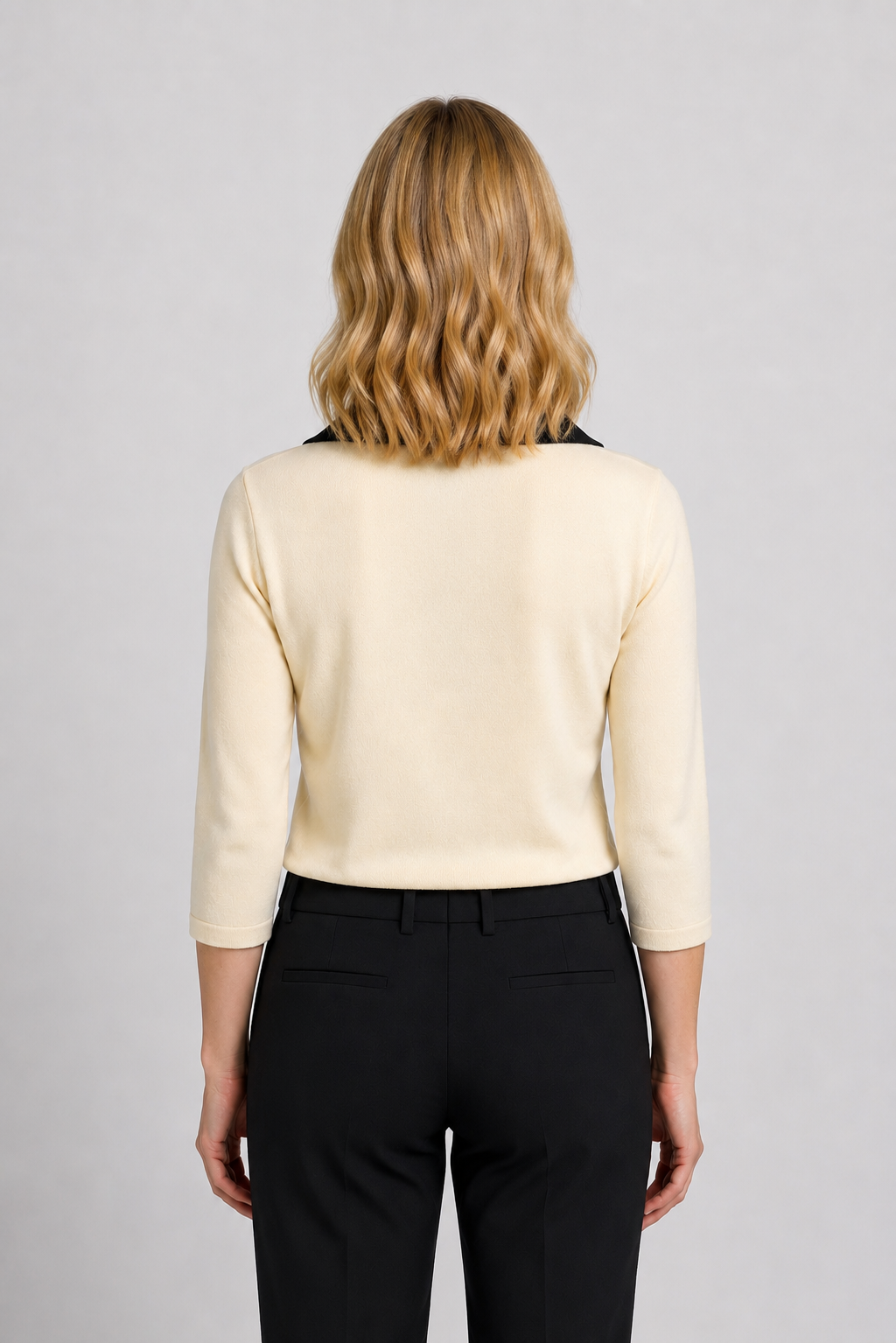 Woman wearing a cream knit top 
