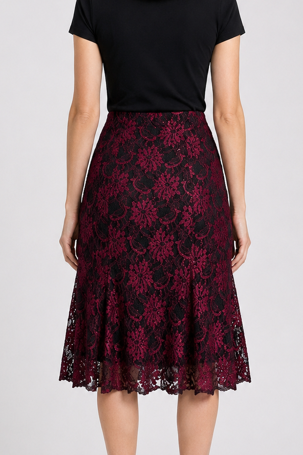 Woman wearing a black top and red floral skirt 
