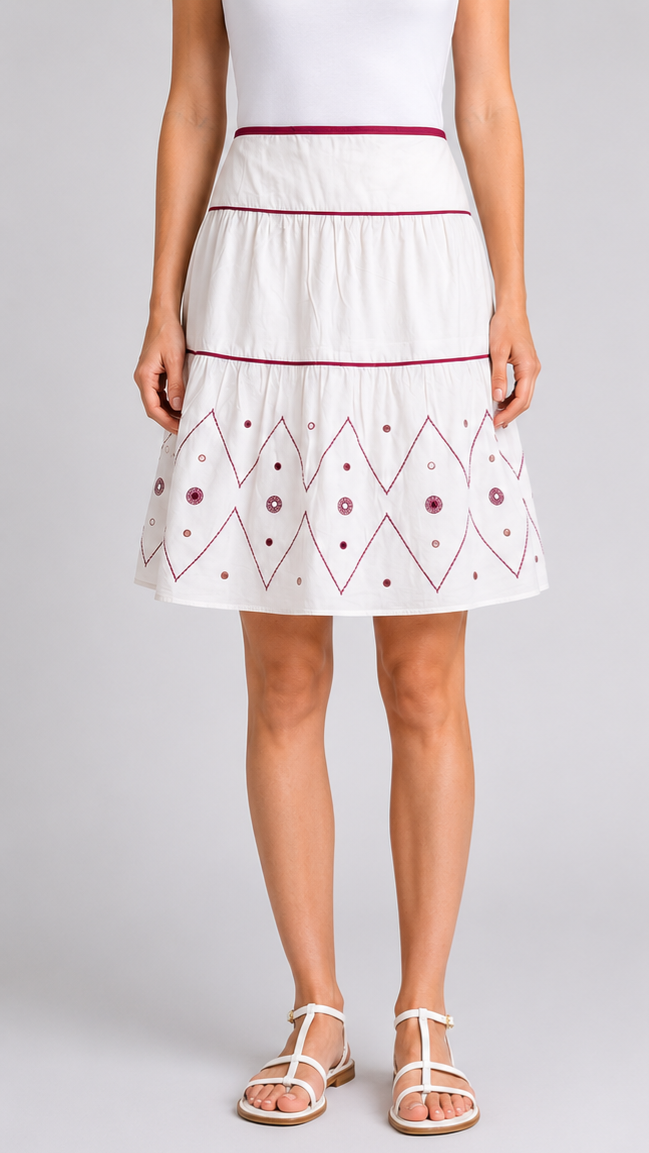 Woman wearing a White skirt with a red embroidery pattern