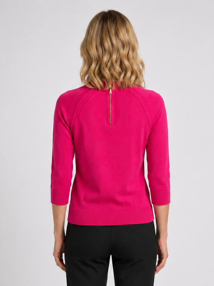 Person wearing a bright pink long-sleeve top with a zip