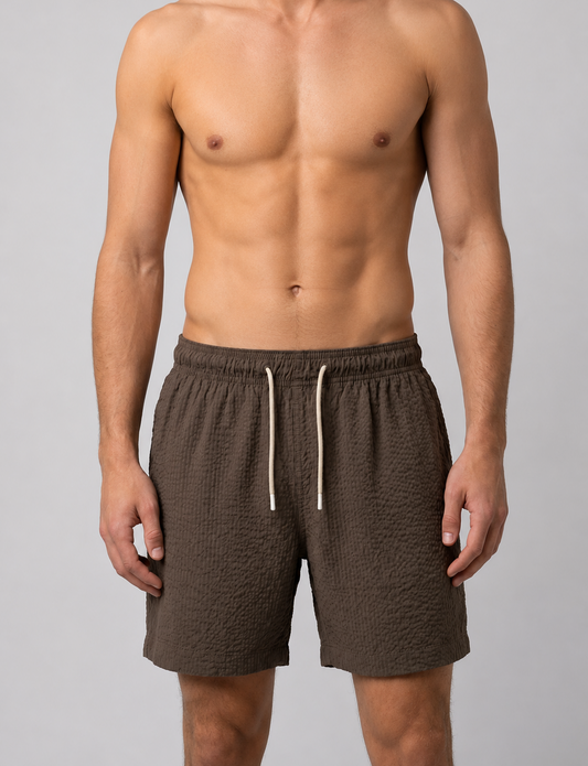 Man wearing brown swim shorts