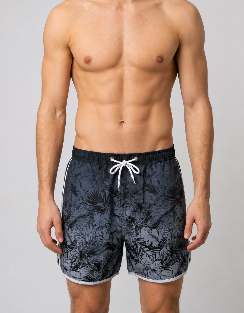 Man wearing black floral swim shorts 