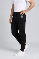 Close up of a man wearing a pair of  black DKNY joggers size M side view
