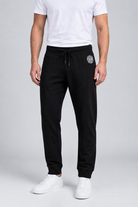 Close up of a man wearing a pair of  black DKNY joggers size M front view
