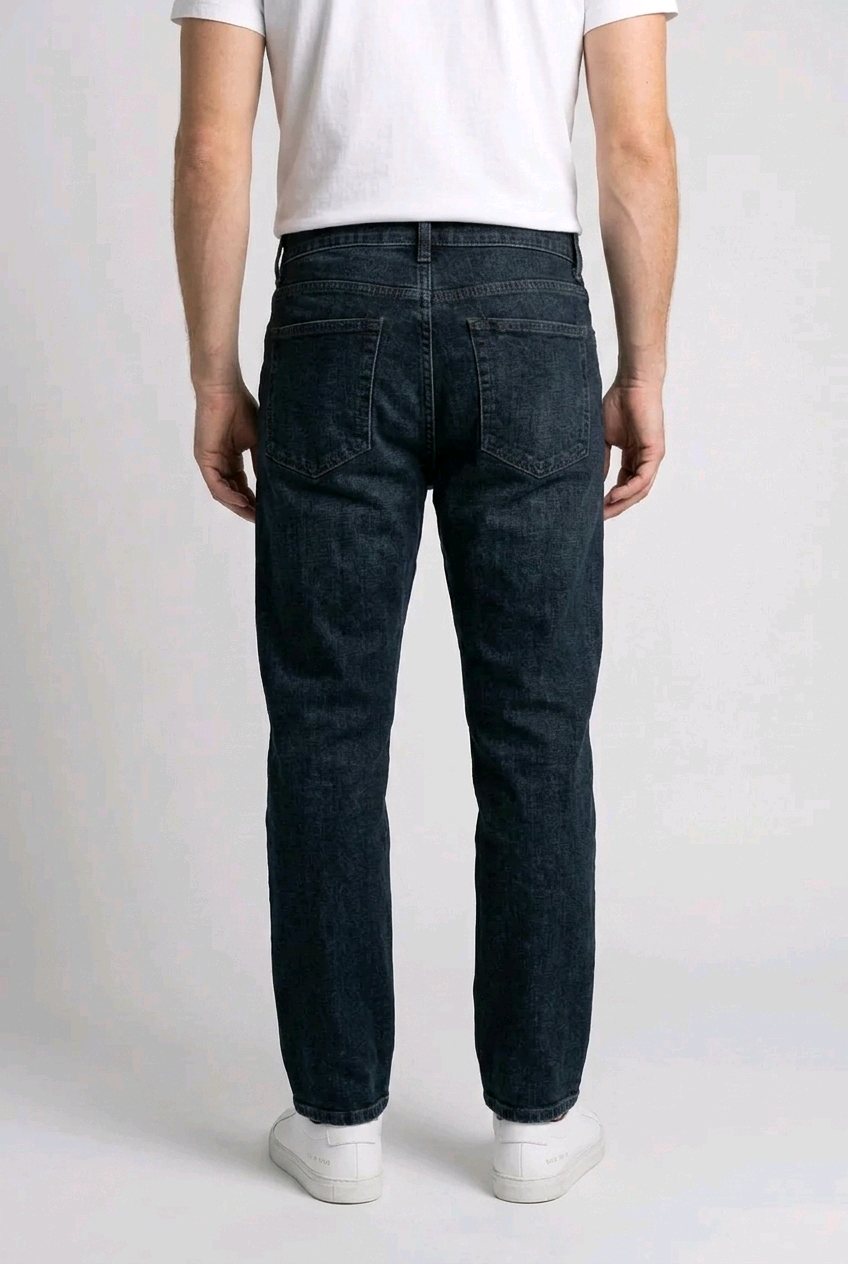 Man wearing dark jeans and a white shirt