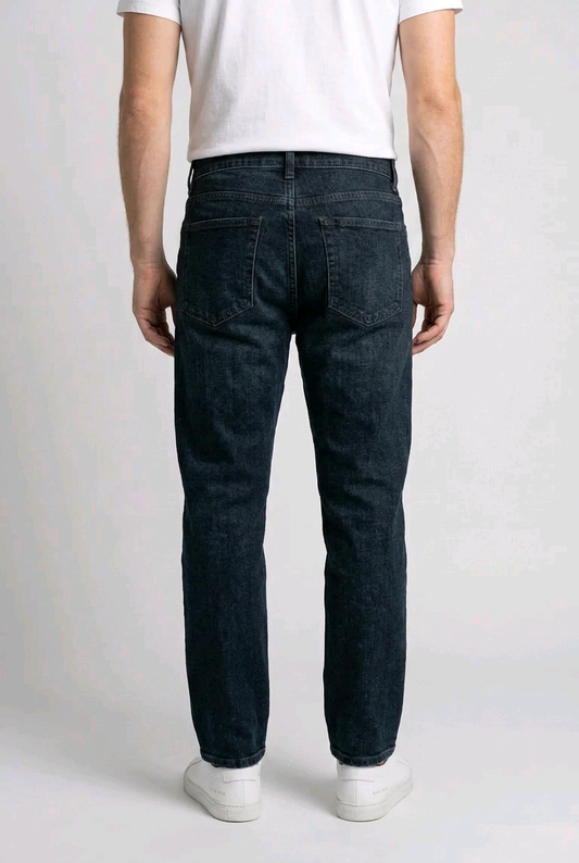 Man wearing dark jeans and a white shirt
