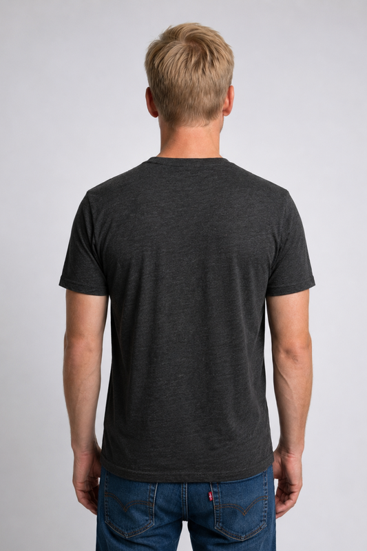 Man wearing a charcoal grey t-shirt and blue jeans