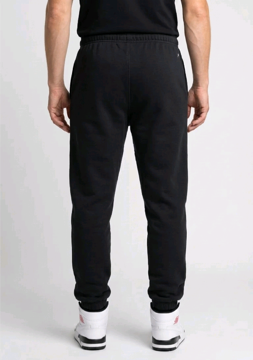 Man wearing black jordan joggers back view