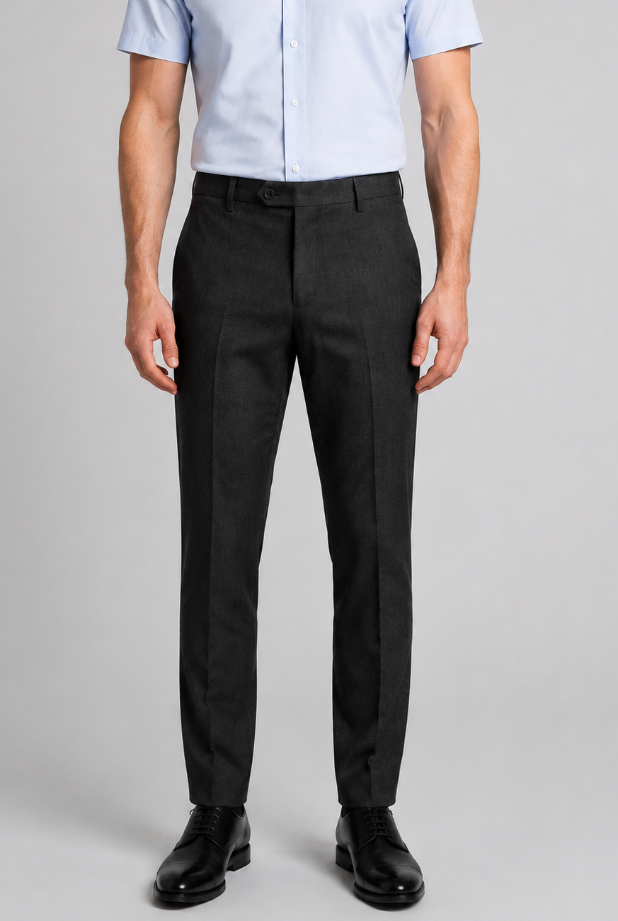 A man wearing charcoal grey trousers and a light blue shirt