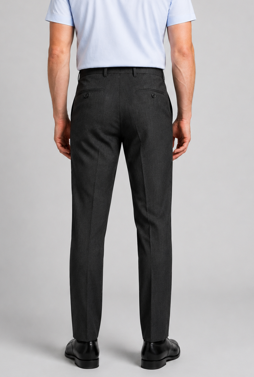 Man wearing charcoal grey trousers and a light blue shirt back view