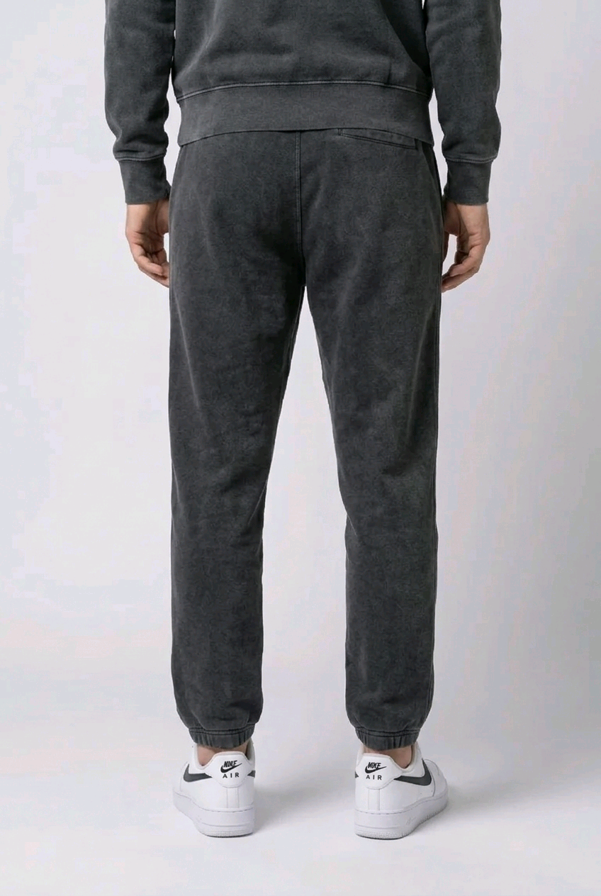 Man wearing black faded Nike joggers