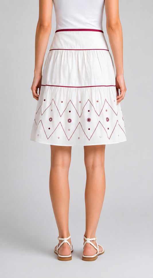 Woman wearing a White skirt with red embroidery 