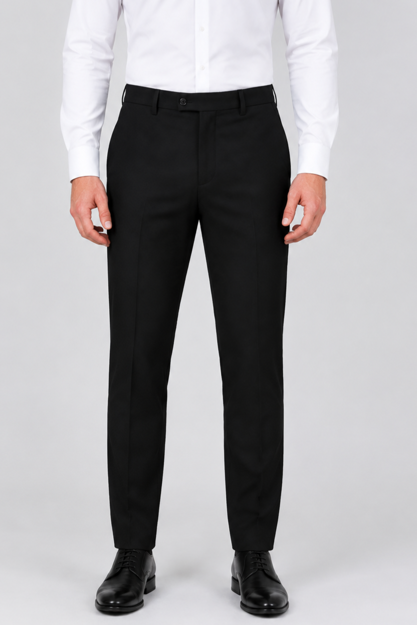 A man wearing slim-fit black dress trousers, a white long-sleeve dress shirt, and black leather dress shoes.