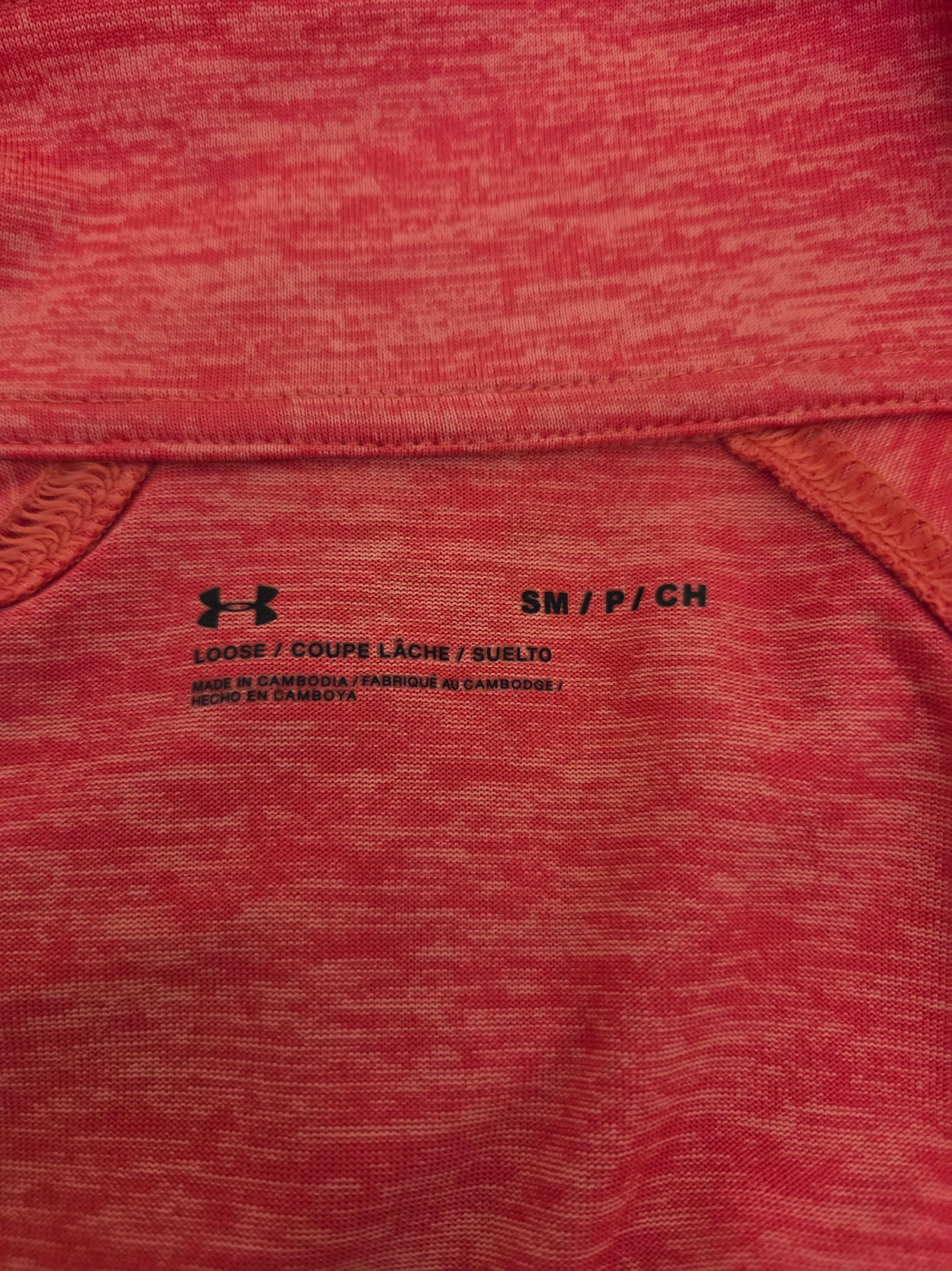 Coral size label with Under Armour logo and text