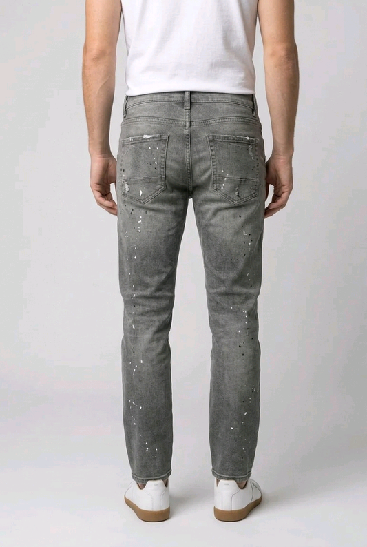 Man wearing gray jeans with white speckles 