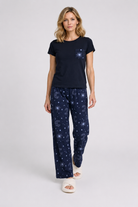 Woman wearing a navy blue t-shirt and matching trousers with a celestial pattern
