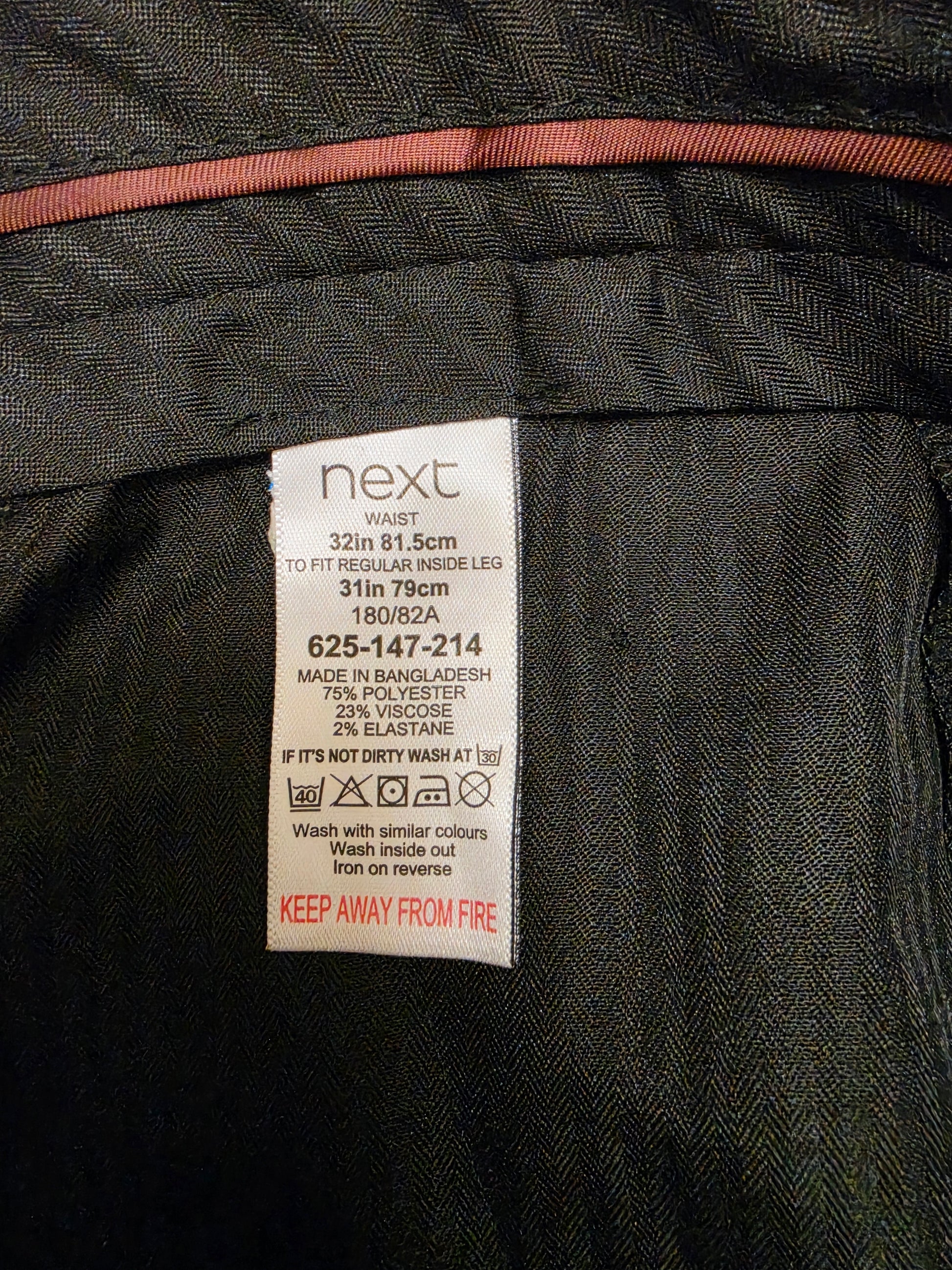 Close-up of a size label reading 'next' 