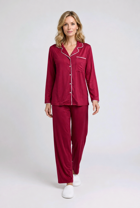 Woman wearing a burgundy pajama set with white buttons 
